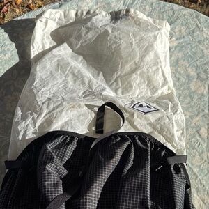 White and Black Backpack with Logo Patch